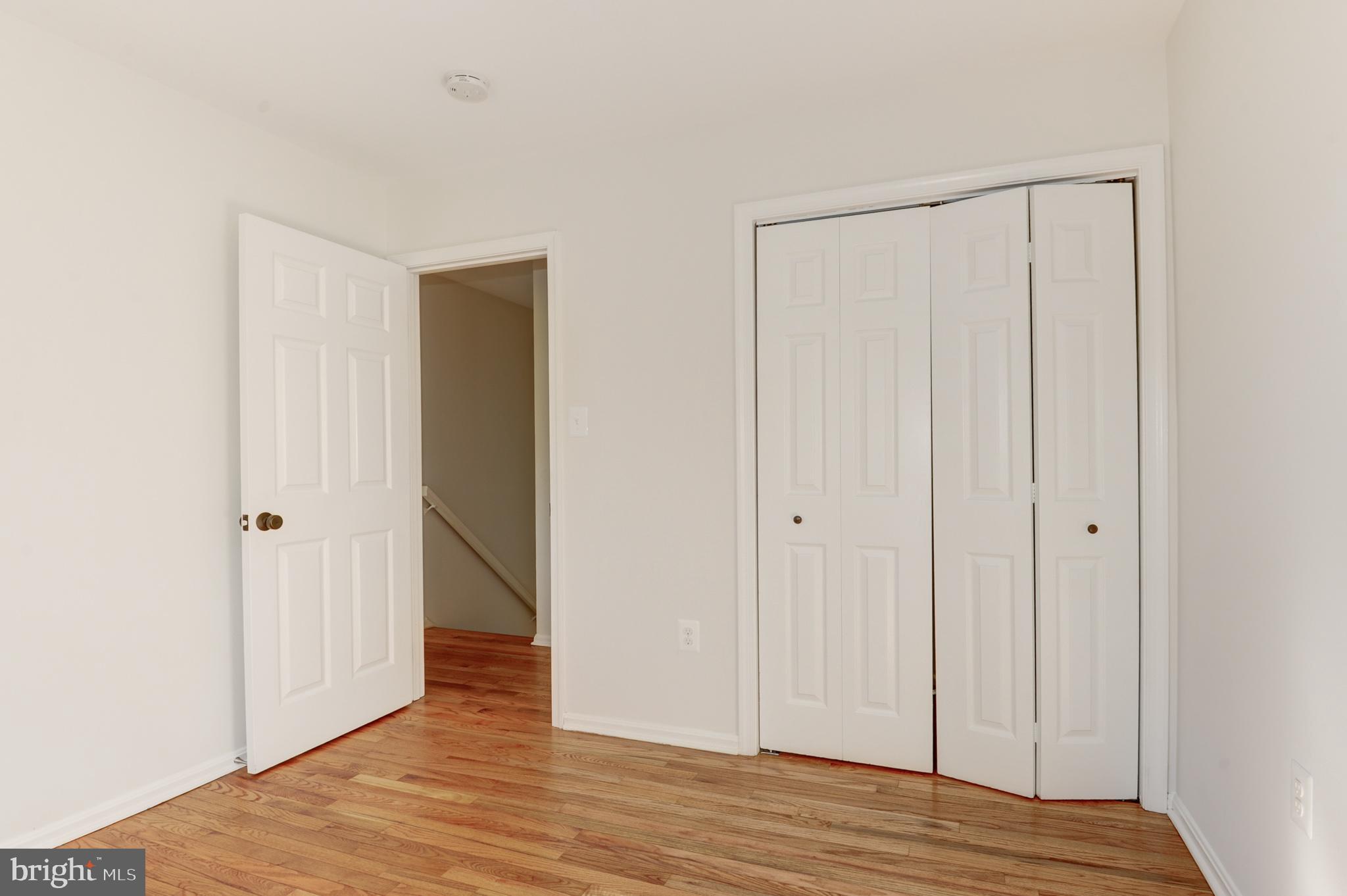 10809 Cross School Road Reston, VA 20191 - Photo 48 of 60 a view of an empty room with wooden floor