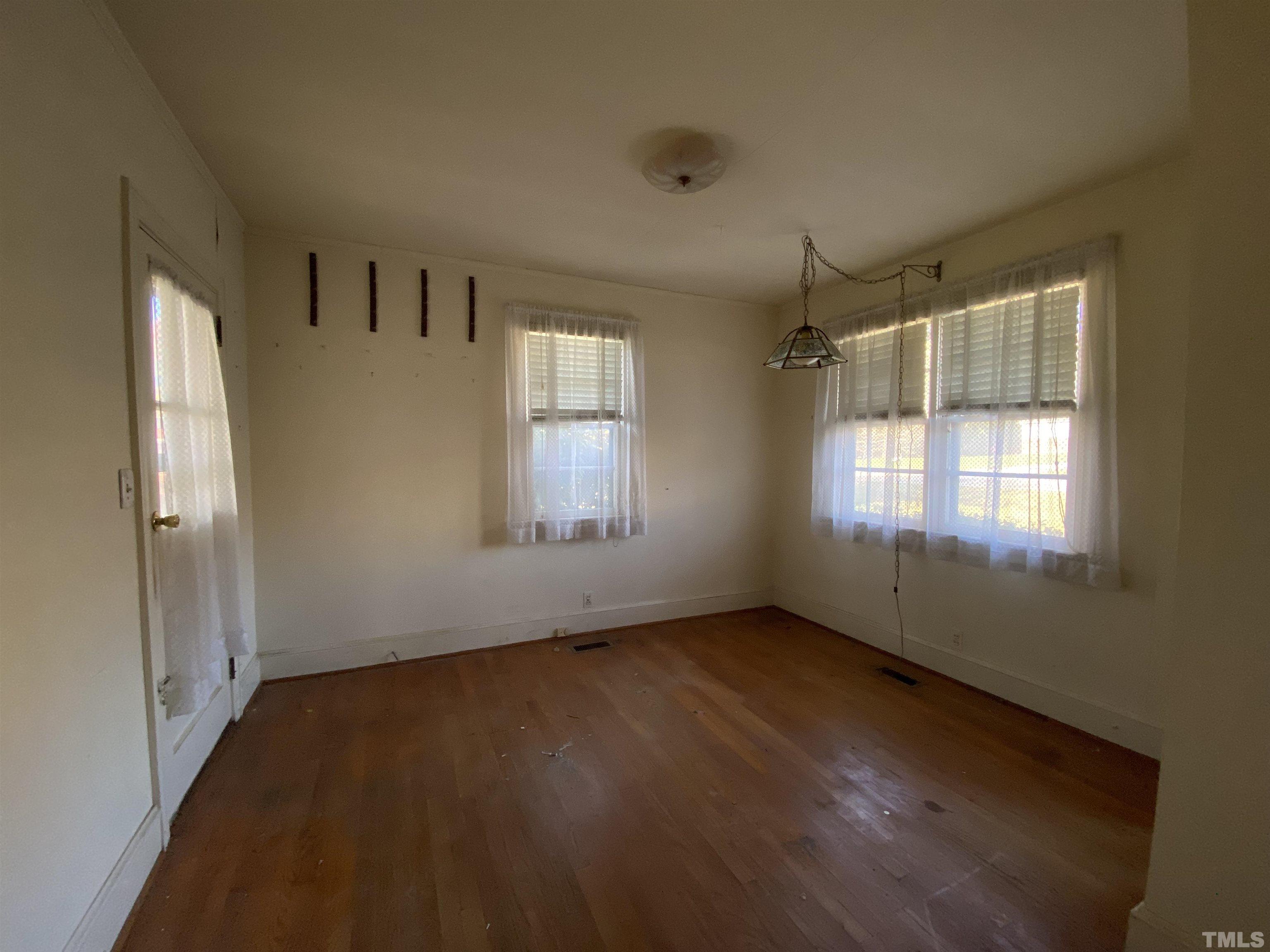 4015 St James Church Road Raleigh, NC 27604 - Photo 9 of 13 a view of an empty room with wooden floor and a window