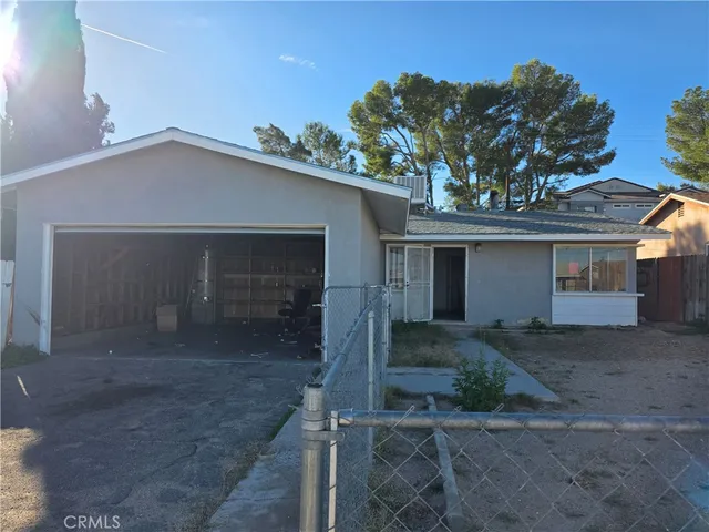 a view of a house with a yard and garage