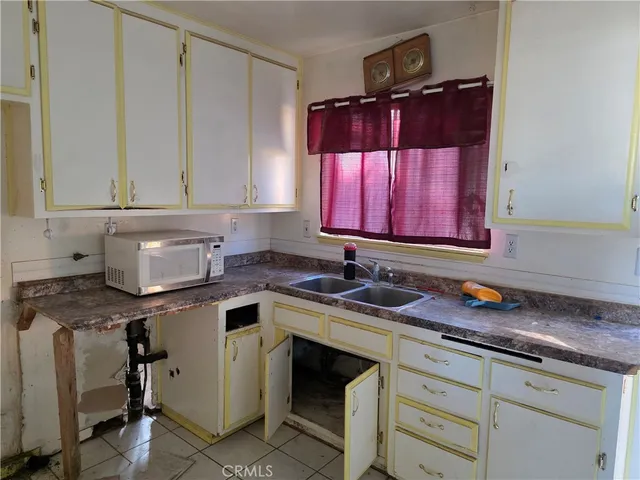a kitchen with stainless steel appliances granite countertop a sink a stove and cabinets