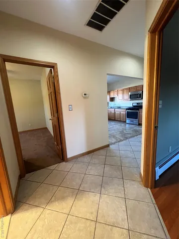 a view of a livingroom with wooden floor and furniture