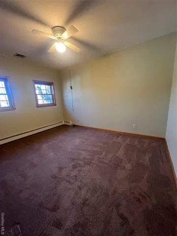 an empty room with a empty space and windows