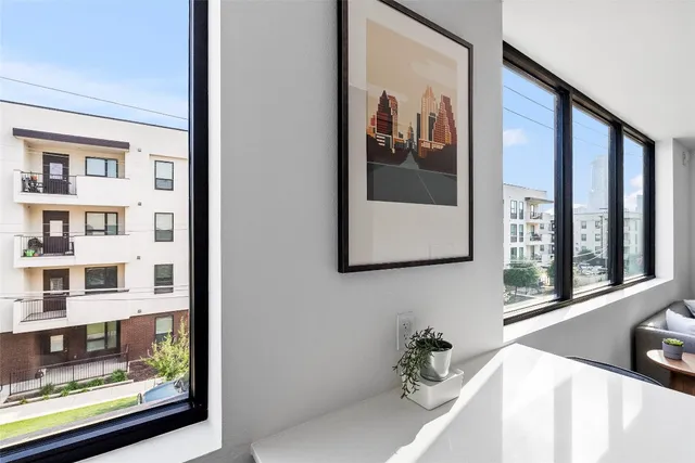 a view of a hallway with wooden floor and furniture