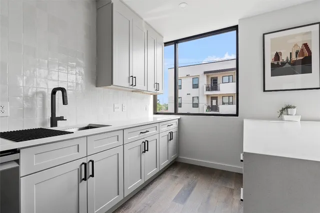 a kitchen with a sink and cabinets