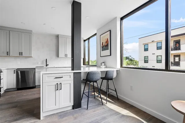 a kitchen with a sink cabinets and window