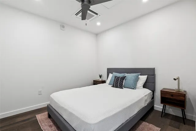 a bedroom with a bed and a lamp