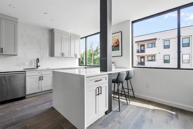 a kitchen with a sink cabinets and wooden floor