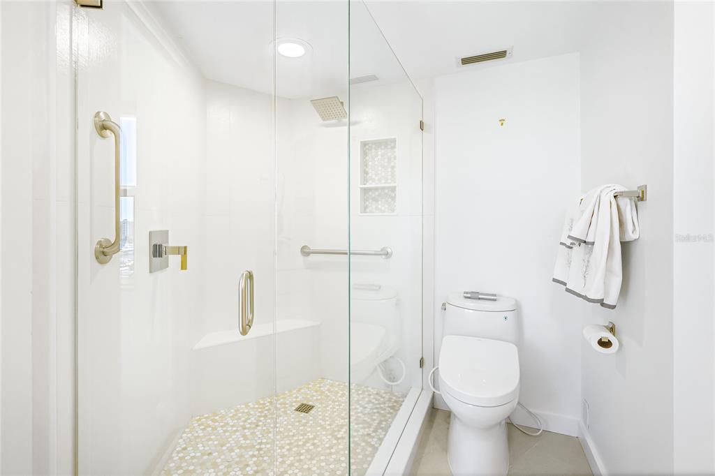 435 South Gulfstream Avenue, Unit 1004 Sarasota, FL 34236 - Photo 17 of 37 a bathroom with a toilet a sink and shower