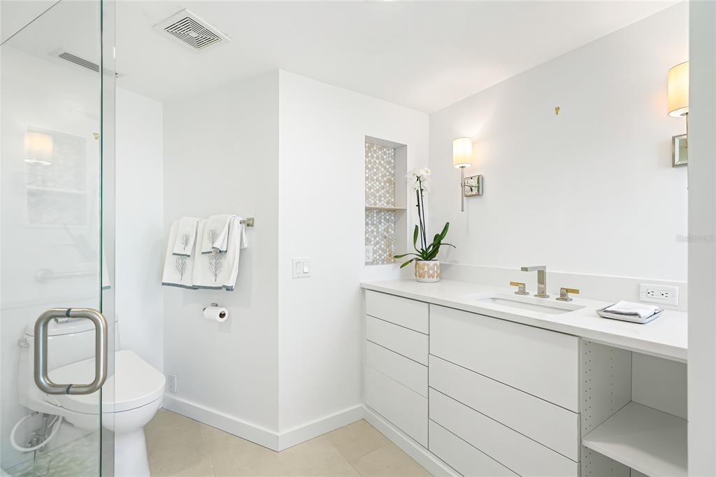 435 South Gulfstream Avenue, Unit 1004 Sarasota, FL 34236 - Photo 18 of 37 a bathroom with a granite countertop sink toilet and shower