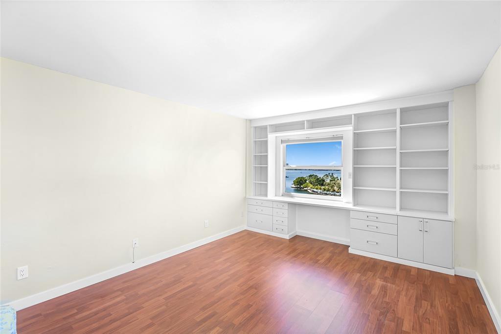 435 South Gulfstream Avenue, Unit 1004 Sarasota, FL 34236 - Photo 21 of 37 a view of an empty room with a window and wooden floor