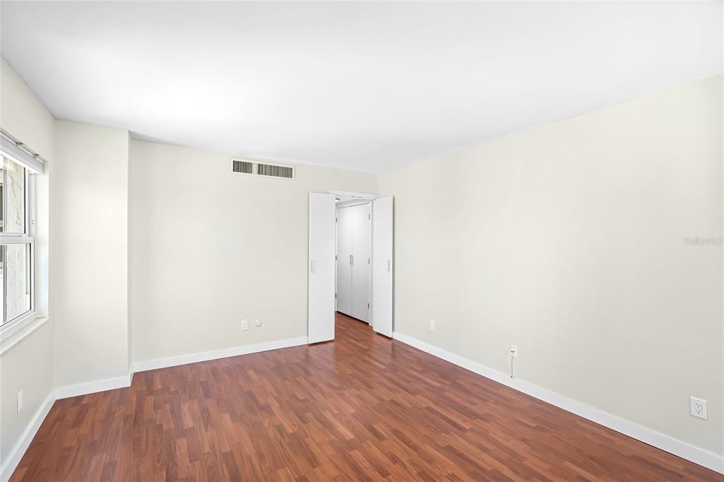 435 South Gulfstream Avenue, Unit 1004 Sarasota, FL 34236 - Photo 22 of 37 an empty room with wooden floor