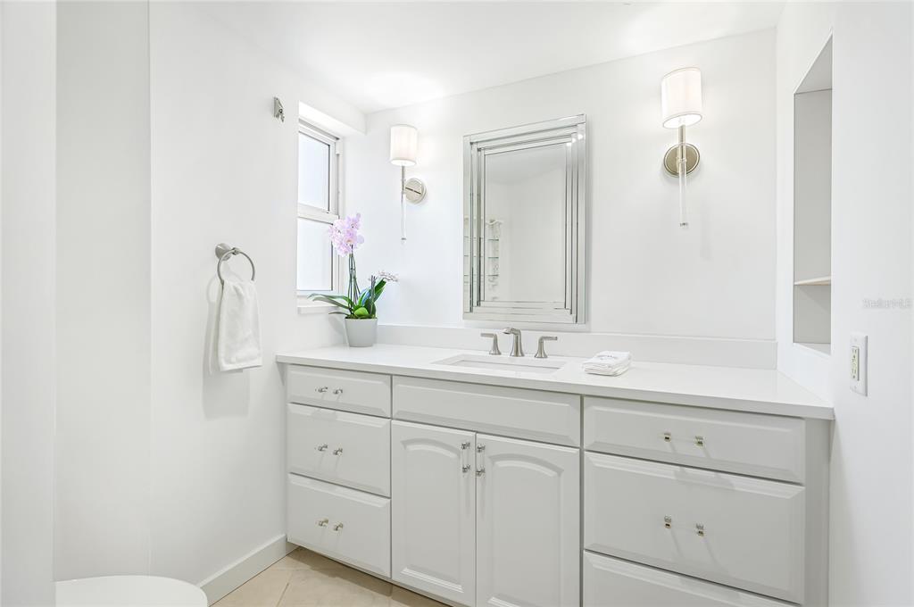 435 South Gulfstream Avenue, Unit 1004 Sarasota, FL 34236 - Photo 25 of 37 a bathroom with a double vanity sink and mirror