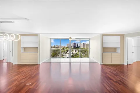 a view of a room with wooden floor and window