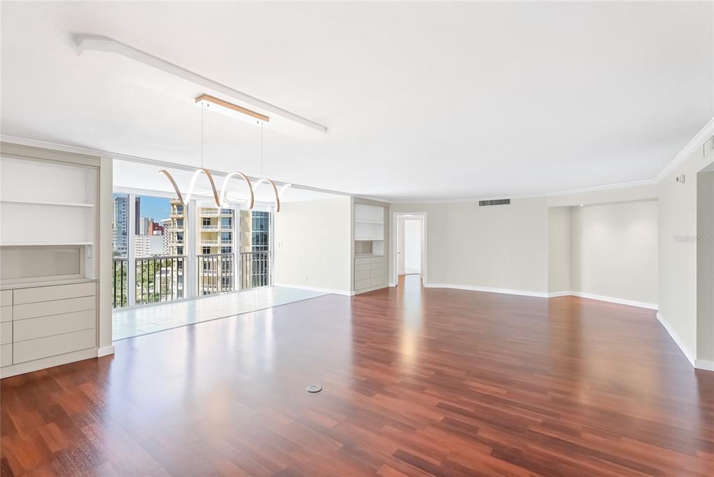 435 South Gulfstream Avenue, Unit 1004 Sarasota, FL 34236 - Photo 6 of 37 a view of an empty room with wooden floor and windows