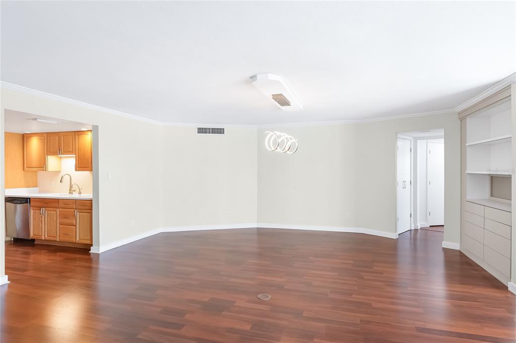 435 South Gulfstream Avenue, Unit 1004 Sarasota, FL 34236 - Photo 10 of 37 a view of an empty room with wooden floor and a window