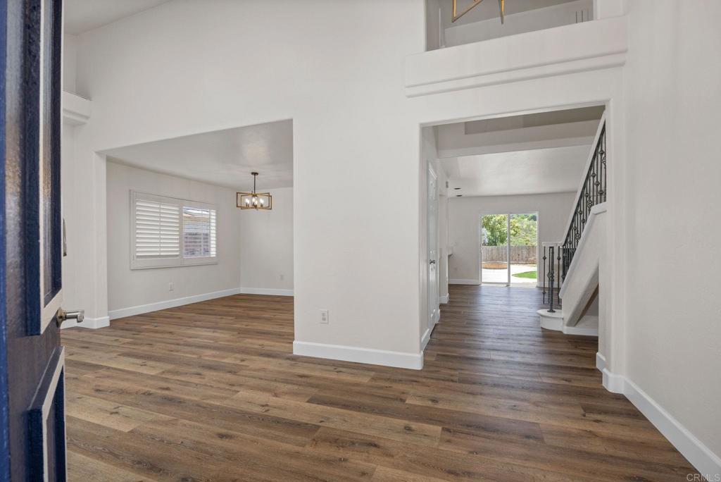 4595 Blackwell Road Oceanside, CA 92056 - Photo 3 of 47 a view of a hallway with wooden floor and a living room