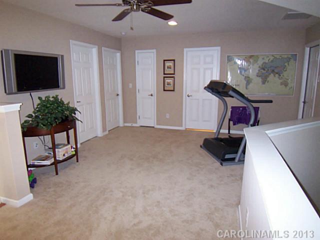 113 Inlet Point Drive, Unit 78 Tega Cay, SC 29708 - Photo 13 of 16 a living room with furniture and a flat screen tv