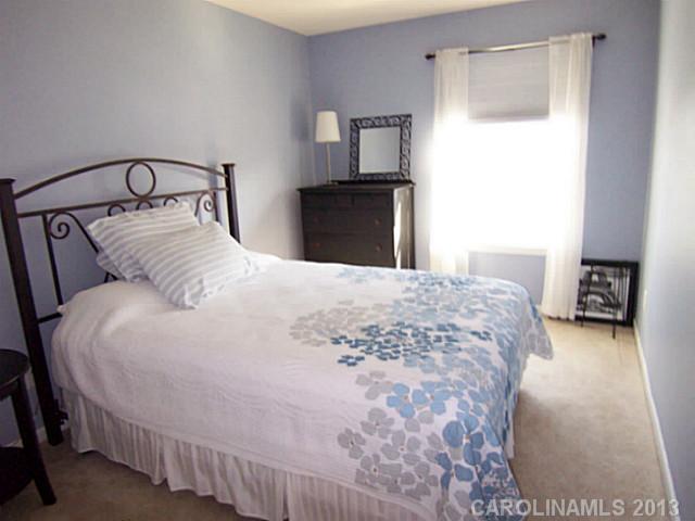 113 Inlet Point Drive, Unit 78 Tega Cay, SC 29708 - Photo 14 of 16 a bedroom with a bed and a television