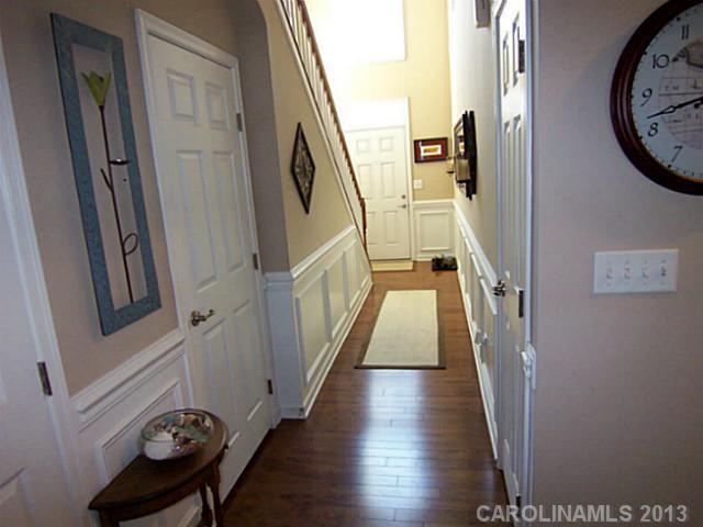 113 Inlet Point Drive, Unit 78 Tega Cay, SC 29708 - Photo 3 of 16 a view of a hallway with wooden floor and stairs