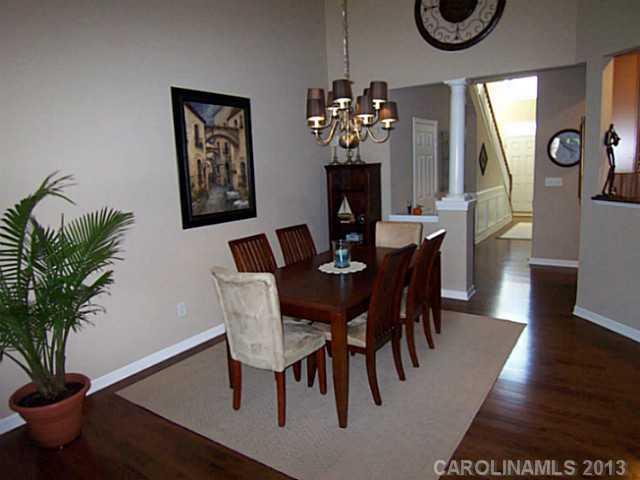 113 Inlet Point Drive, Unit 78 Tega Cay, SC 29708 - Photo 4 of 16 a view of a dining room with furniture and wooden floor