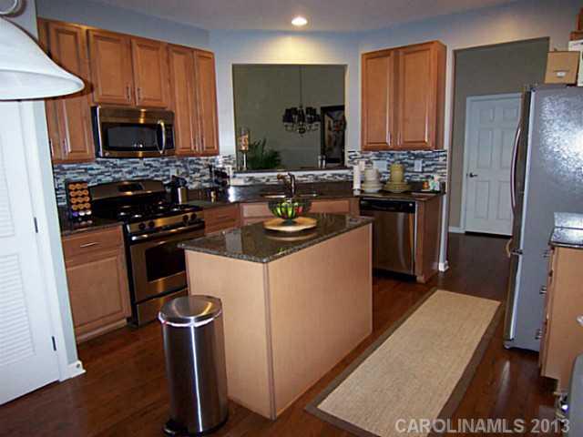113 Inlet Point Drive, Unit 78 Tega Cay, SC 29708 - Photo 6 of 16 a kitchen with a refrigerator stove and microwave