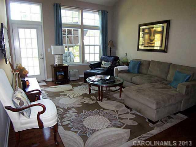 113 Inlet Point Drive, Unit 78 Tega Cay, SC 29708 - Photo 7 of 16 a living room with furniture and a large window