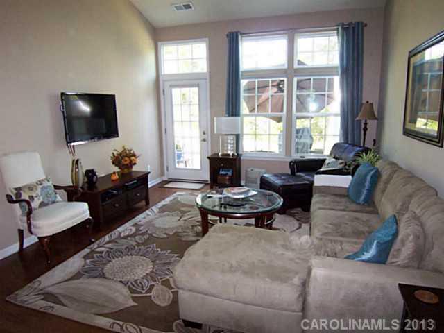 113 Inlet Point Drive, Unit 78 Tega Cay, SC 29708 - Photo 8 of 16 a living room with furniture and a flat screen tv
