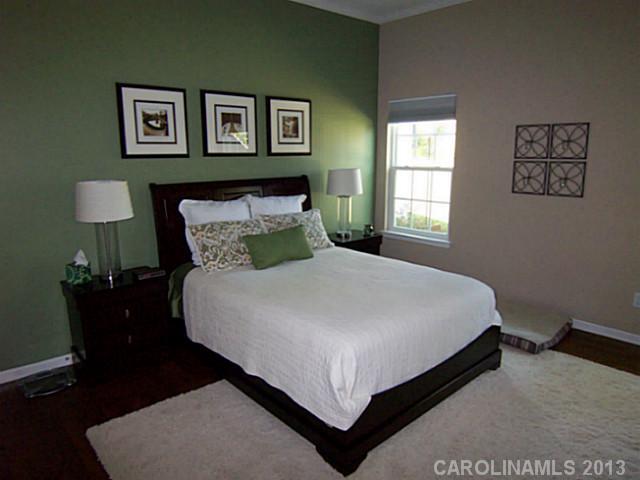 113 Inlet Point Drive, Unit 78 Tega Cay, SC 29708 - Photo 9 of 16 a bedroom with a bed and painting on the wall