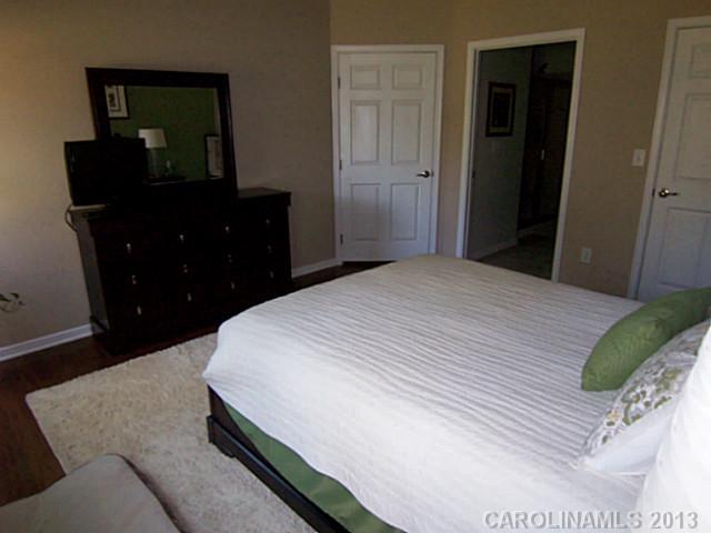 113 Inlet Point Drive, Unit 78 Tega Cay, SC 29708 - Photo 10 of 16 a bedroom with a bed and dresser with mirror