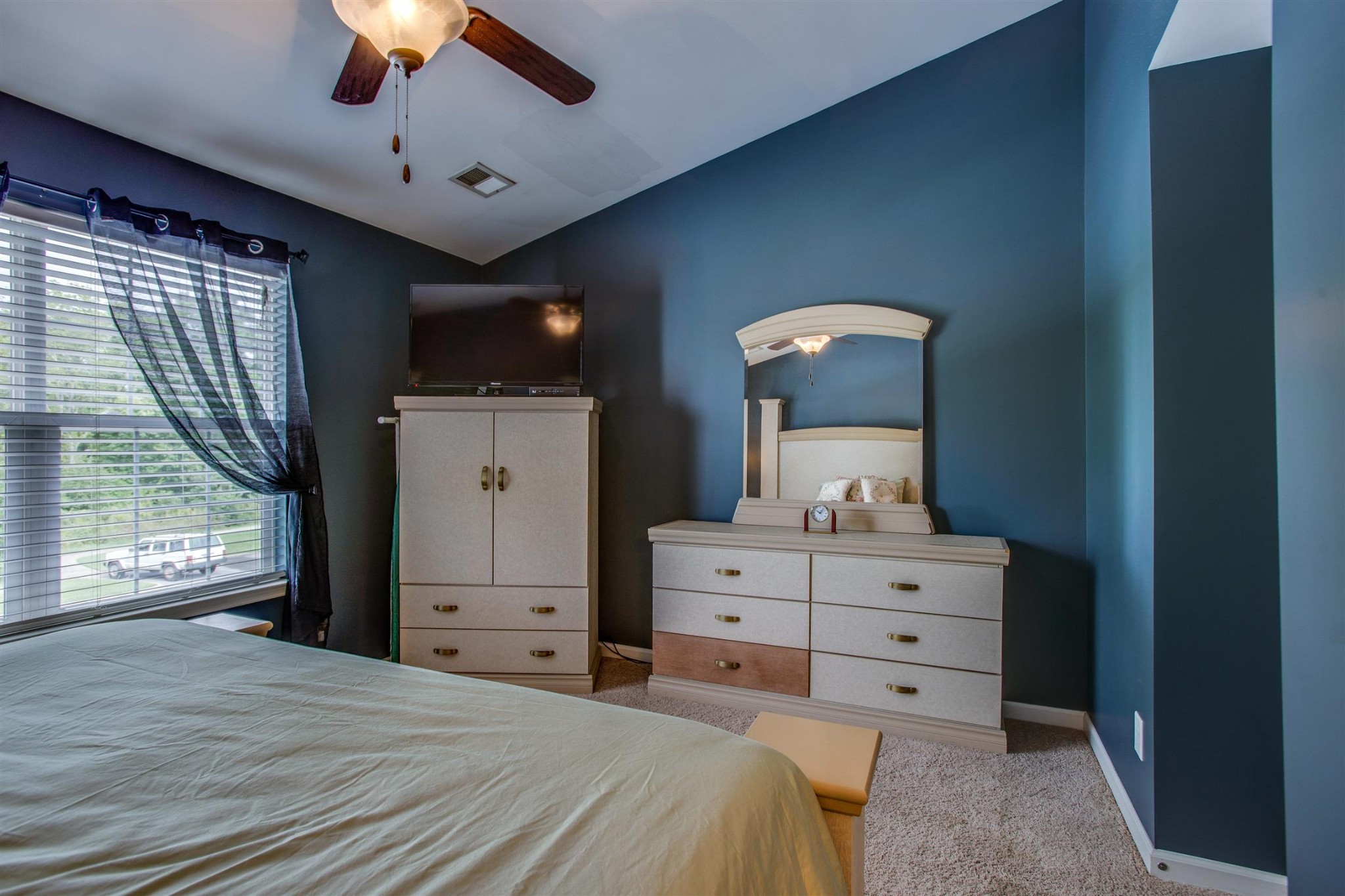 2015 Hemlock Drive Spring Hill, TN 37174 - Photo 12 of 22 a bedroom with a bed and a flat tv screen on dresser