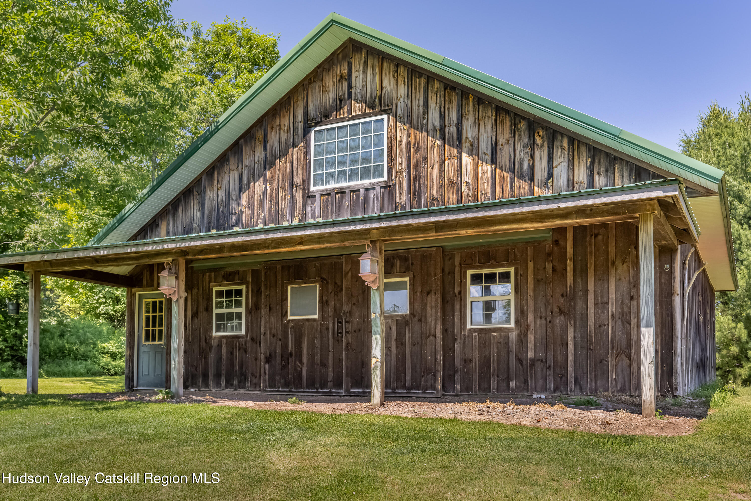 688 Bruce Porn Road Gilboa, NY 12167 - Photo 38 of 104 a front view of a house with a garden
