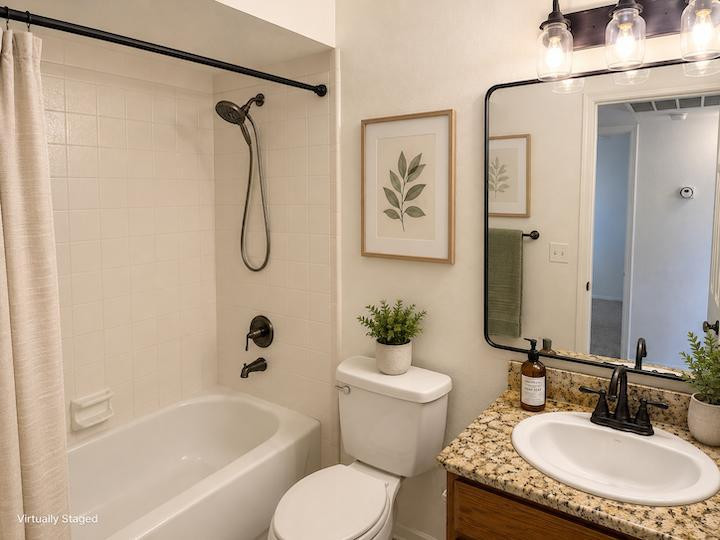 170 East Guadalupe Road, Unit 62 Gilbert, AZ 85234 - Photo 8 of 12 a bathroom with a granite countertop sink toilet and shower