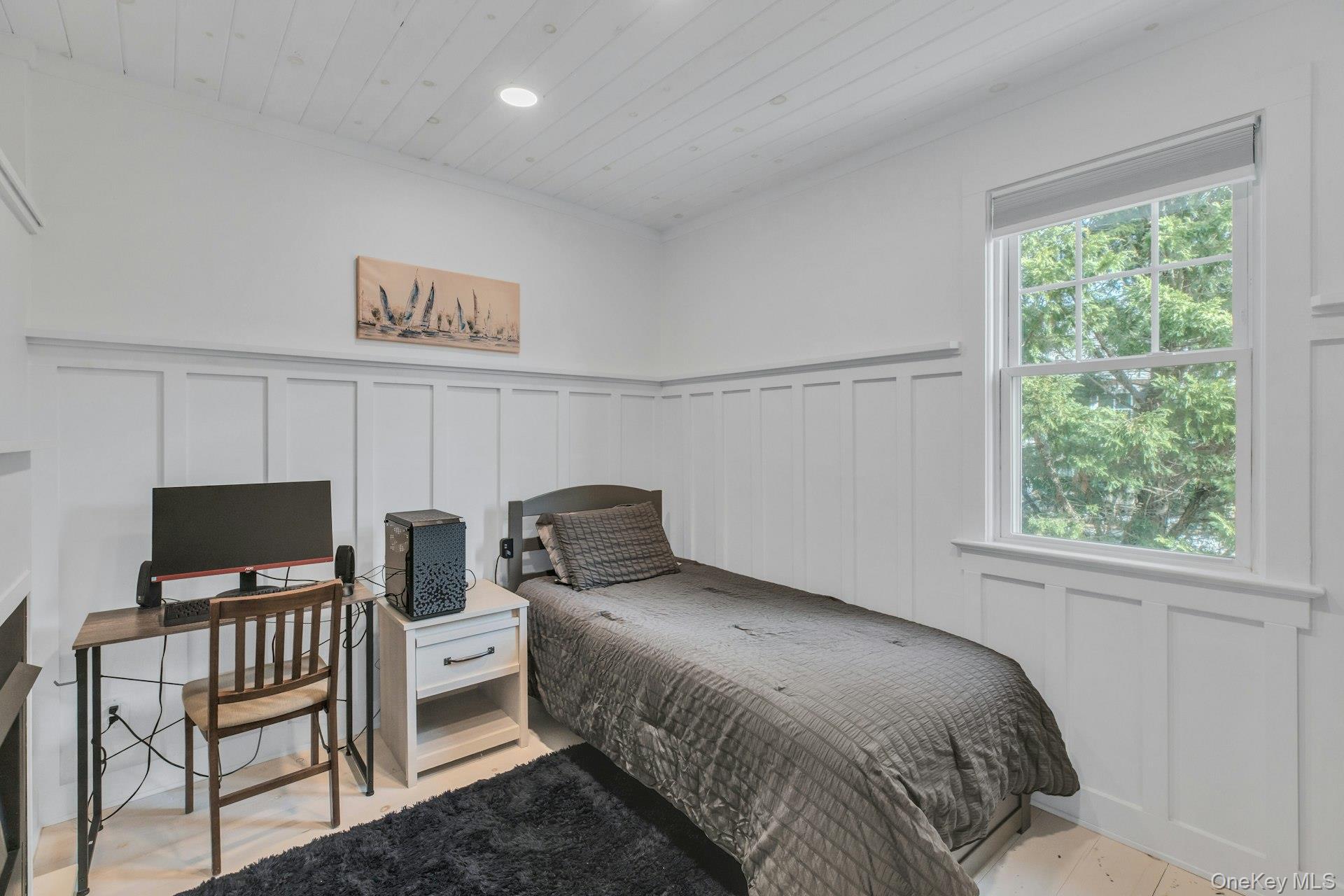 7 Springville Circle Hampton Bays, NY 11946 - Photo 15 of 43 Bedroom with a decorative wall, wooden ceiling, a wainscoted wall, and an office area
