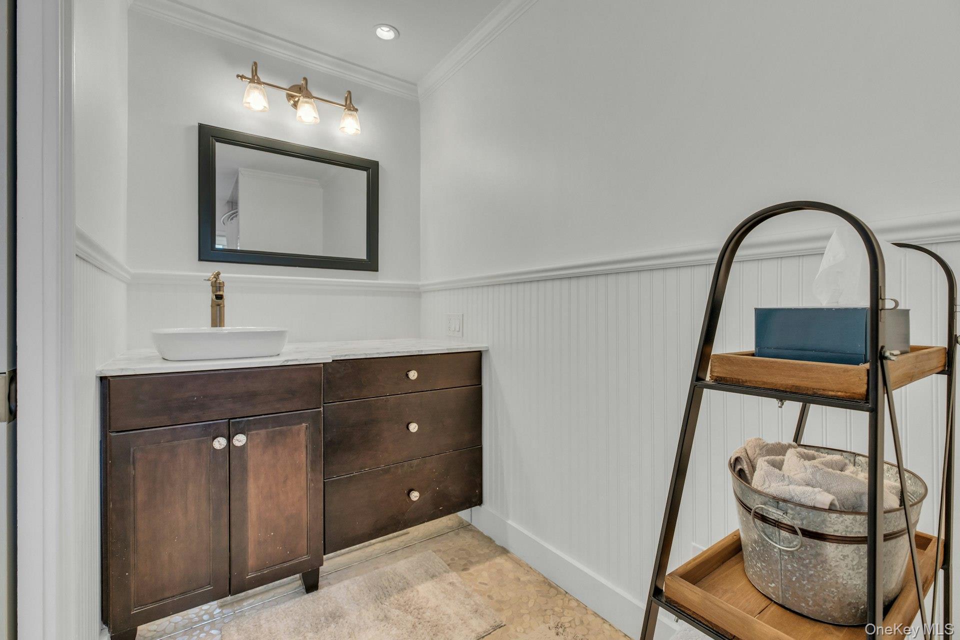 7 Springville Circle Hampton Bays, NY 11946 - Photo 18 of 43 Bathroom featuring vanity, a wainscoted wall, and crown molding