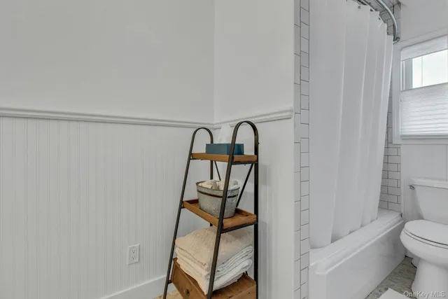 a bathroom with a shower toilet and a sink