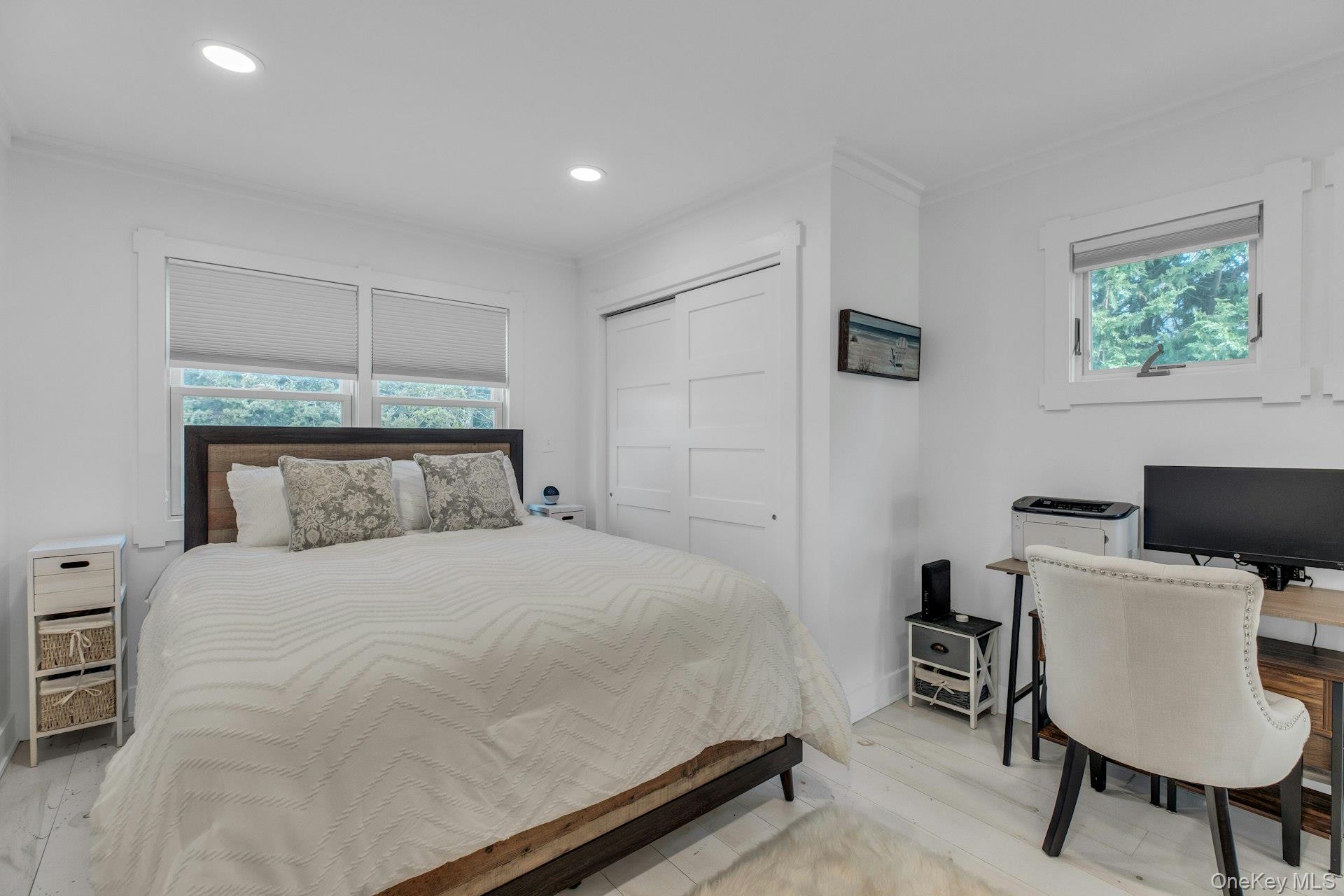 7 Springville Circle Hampton Bays, NY 11946 - Photo 21 of 43 Bedroom with an office area, multiple windows, ornamental molding, a closet, and recessed lighting