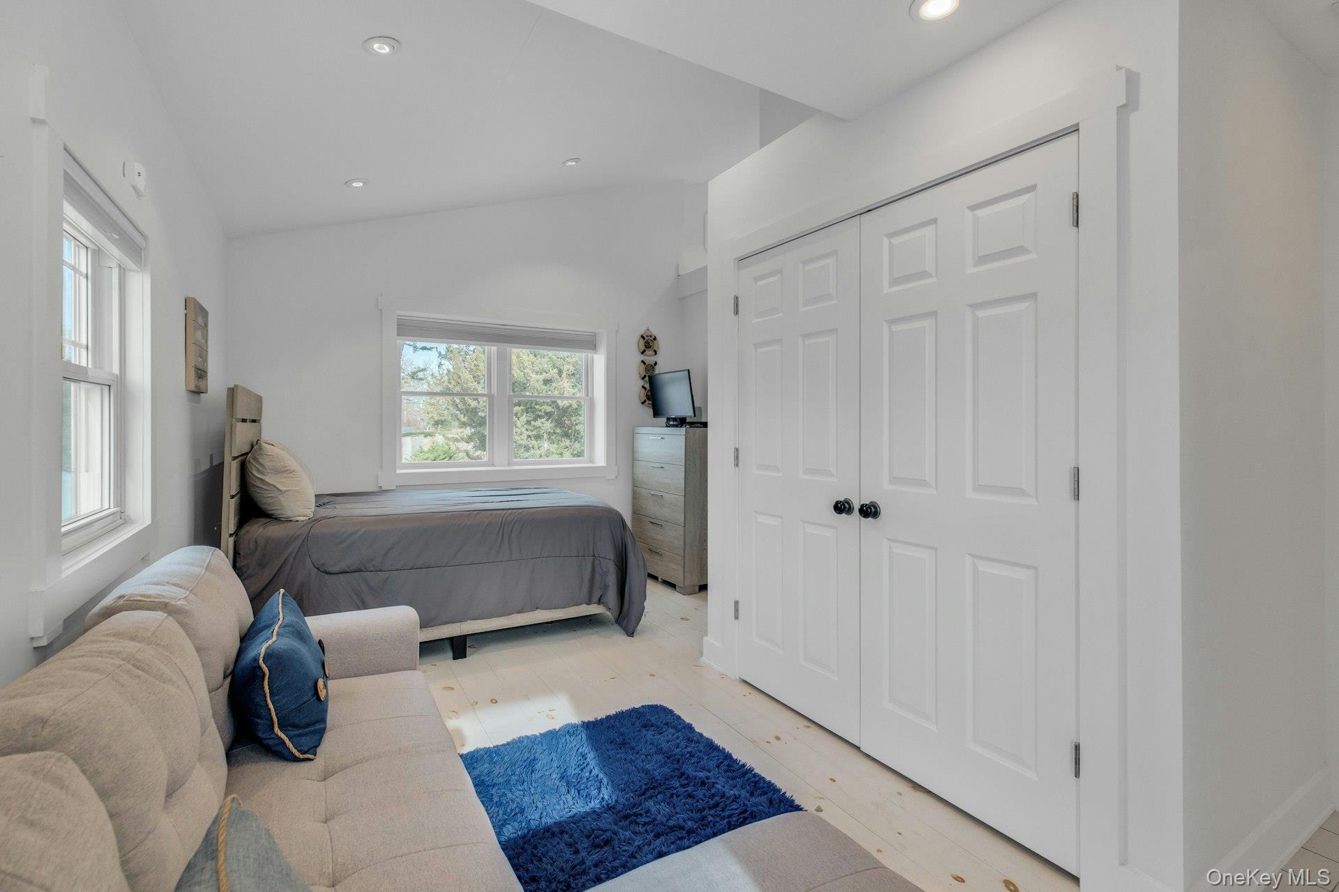 7 Springville Circle Hampton Bays, NY 11946 - Photo 22 of 43 Bedroom featuring lofted ceiling, light wood-style flooring, recessed lighting, and a closet