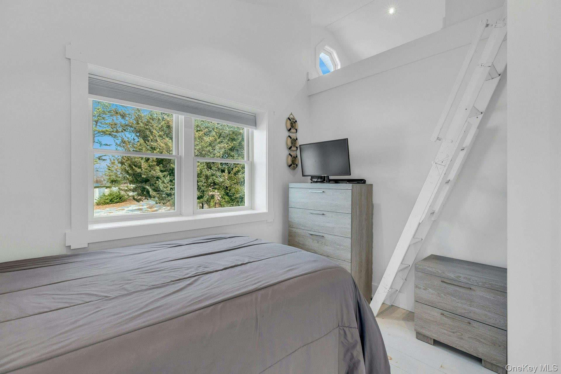 7 Springville Circle Hampton Bays, NY 11946 - Photo 23 of 43 Bedroom featuring lofted ceiling and light wood-style flooring
