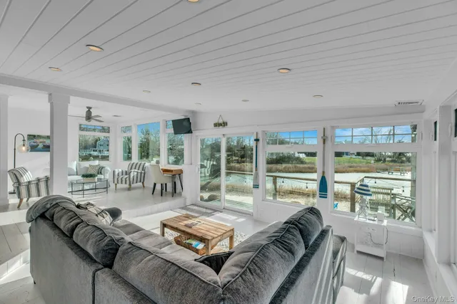 a living room with furniture and large windows