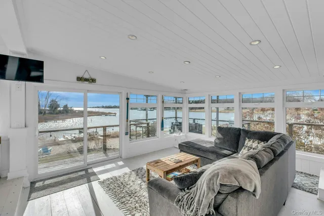 a living room with furniture and a floor to ceiling window