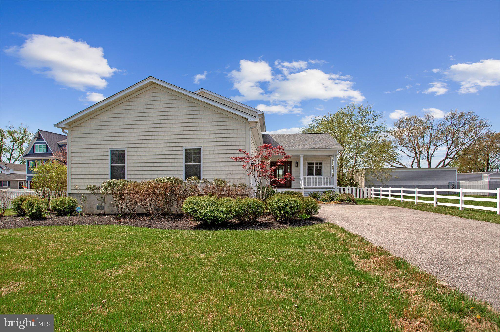 6146 Drum Point Road Deale, MD 20751 - Photo 4 of 75 a front view of a house with a yard and garage