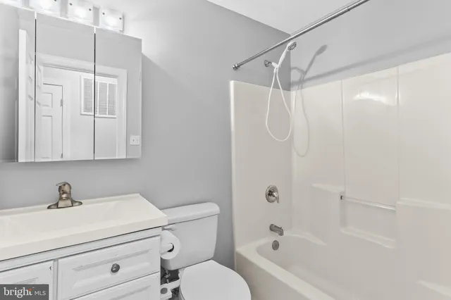 a bathroom with a shower a sink and a mirror
