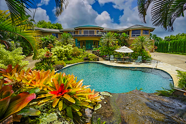 4700 Kapuna Road Kilauea, HI 96754 - Photo 1 of 17 a front view of a house with a yard