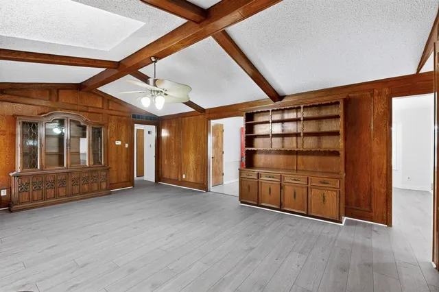 an empty room with furniture and wooden floors