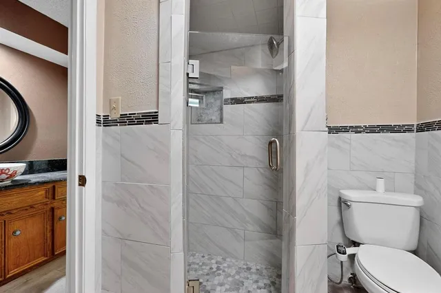 a bathroom with a toilet and a shower