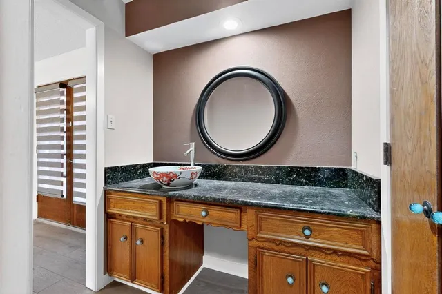 a sink sitting in a kitchen next to a window