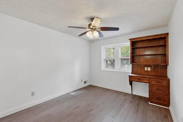 a view of a workspace with furniture and wooden floor