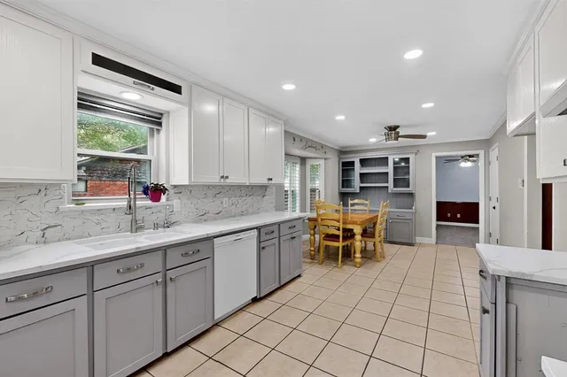 a kitchen with stainless steel appliances granite countertop a sink and cabinets