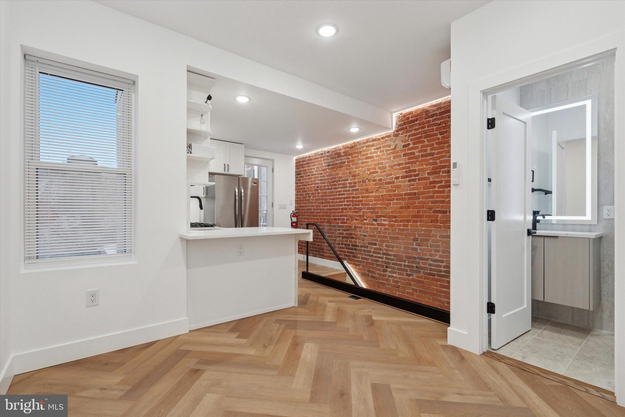 1438 Tasker Street, Unit 3 Philadelphia, PA 19145 - Photo 6 of 9 a view of hallway with stairs and wooden floor