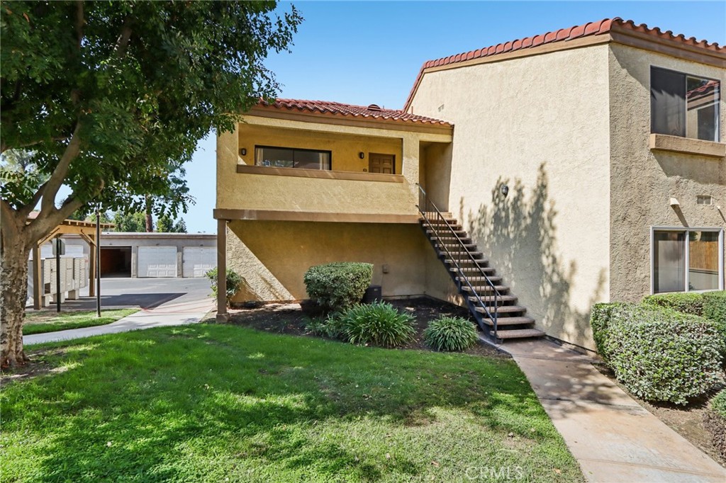 1142 West Blaine Street, Unit 201 Riverside, CA 92507 - Photo 1 of 24 a front view of a house with a yard